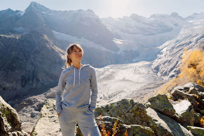 Portrait of young woman standing on mountain