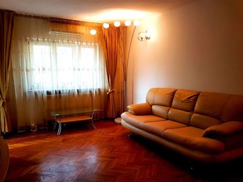 Empty chairs on hardwood floor at home