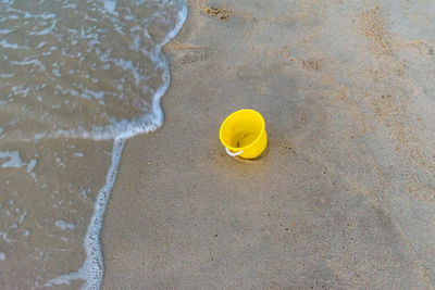 High angle view of yellow umbrella on beach