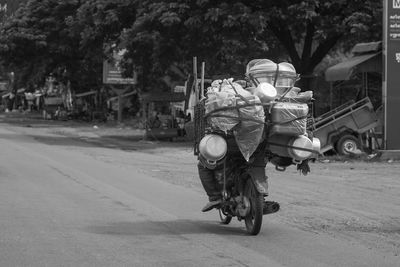 Man carrying luggage on motorcycle