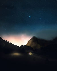 Scenic view of mountains against sky at night