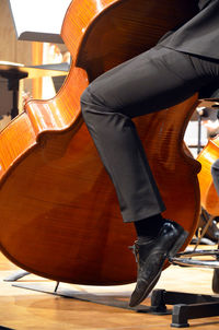 Low section of musician playing double bass