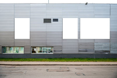 Three blank white billboard for advertisement on the facade of building, outdoor advertising mockup