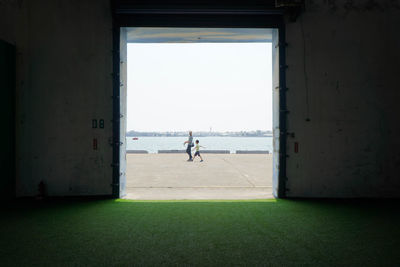 People playing soccer against clear sky