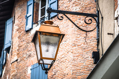 Low angle view of street light against building