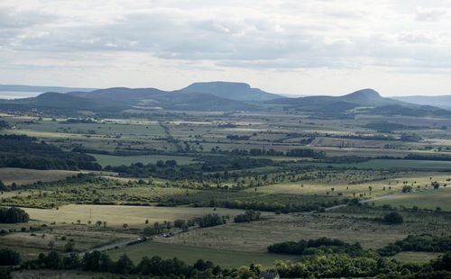 Scenic view of field and mountains against sky