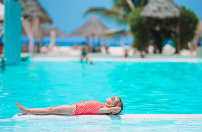 Woman relaxing in swimming pool