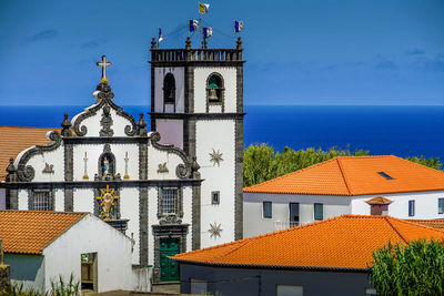 Low angle view of building by sea against sky