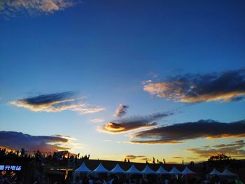 Low angle view of silhouette buildings against sky at sunset