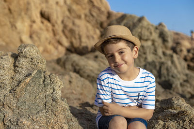 Portrait of boy on rock