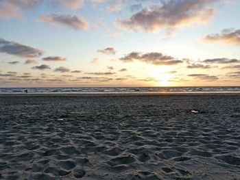 Scenic view of beach against sky during sunset