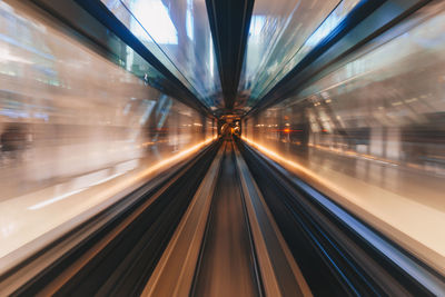 Blurred motion of train at railroad station