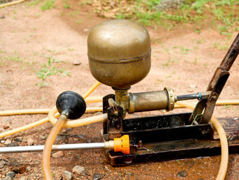 Close-up of machine in container on land