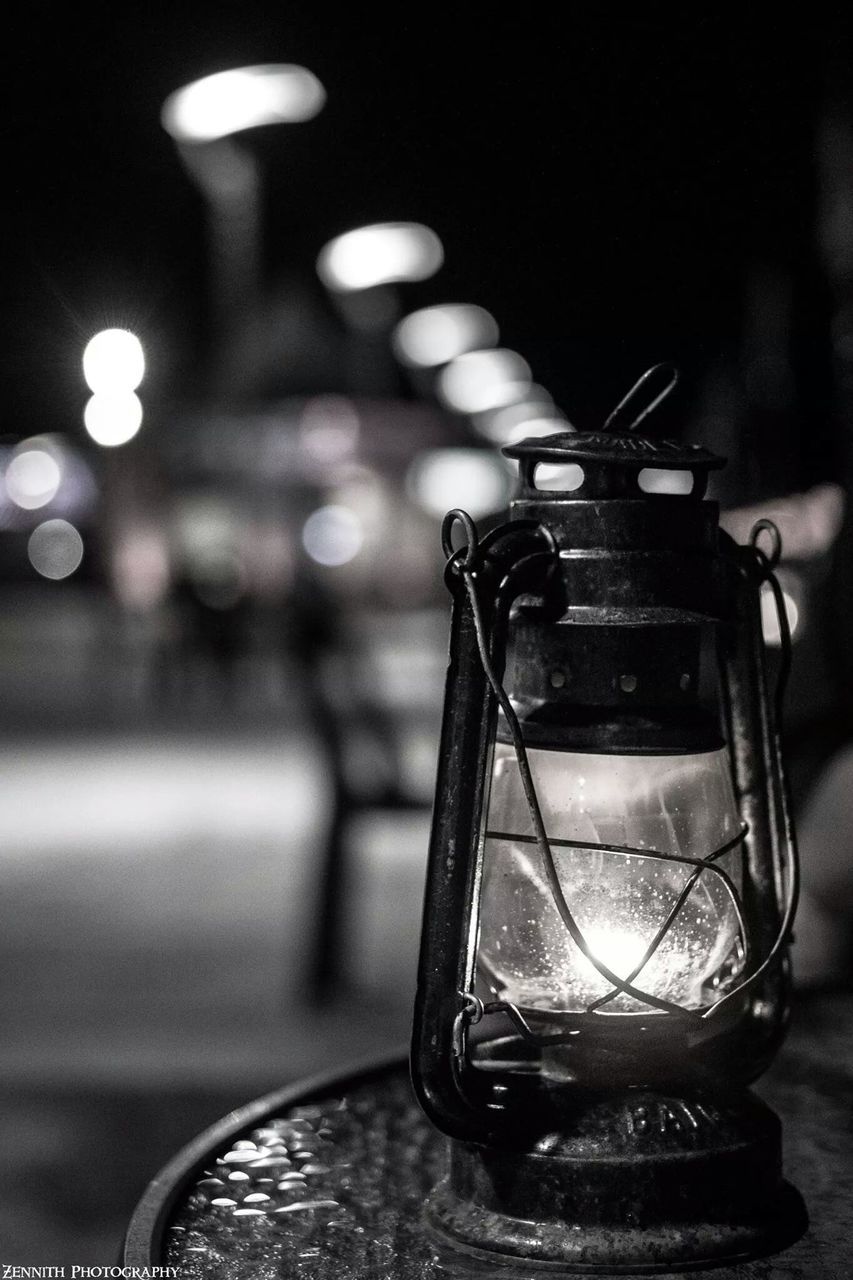 indoors, table, still life, close-up, focus on foreground, illuminated, old-fashioned, absence, metal, glass - material, retro styled, no people, single object, chair, empty, technology, home interior, wall - building feature, night, lighting equipment