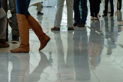 Low section of woman standing on tiled floor