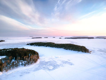 Scenic view of the frozen sea against sky during sunset