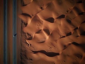 Aerial view of road by sand at desert
