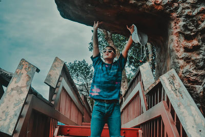 Low angle view of girl standing against built structure