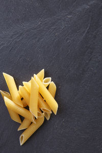 Close-up of penne on slate