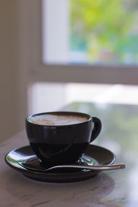 Close-up of coffee cup on table