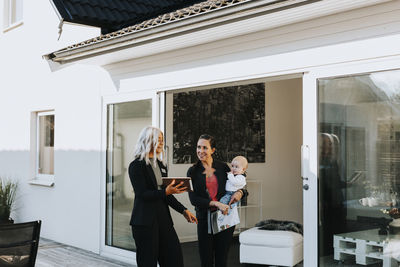 Estate agent showing woman house