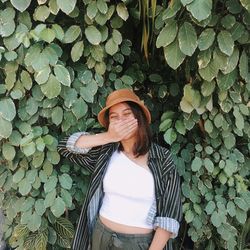 Low section of woman standing by leaves