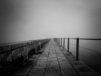 Empty footpath during foggy weather