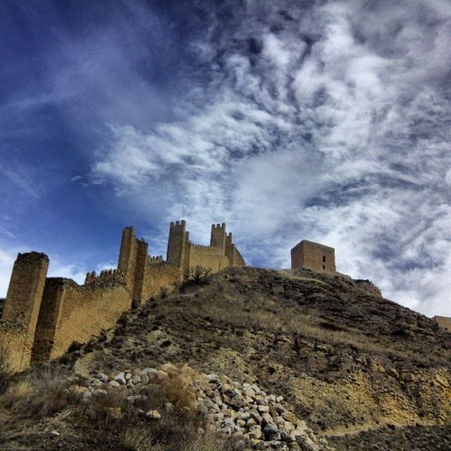 architecture, built structure, sky, building exterior, cloud - sky, low angle view, history, cloud, old ruin, cloudy, old, stone wall, blue, day, the past, outdoors, ancient, damaged, rock - object, no people