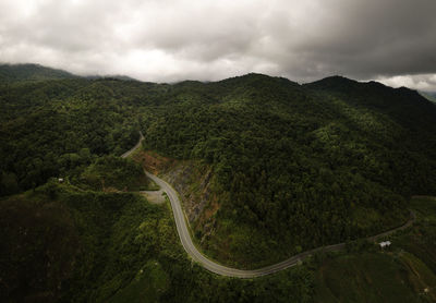 Aerial view of countryside road on the lush greenery tropical rain forest mountain landscape