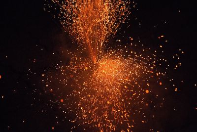 High angle view of firework display at night