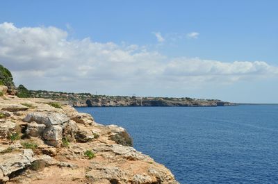 Scenic view of sea against cloudy sky