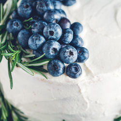 High angle view of blueberries and rosemary on sweet food