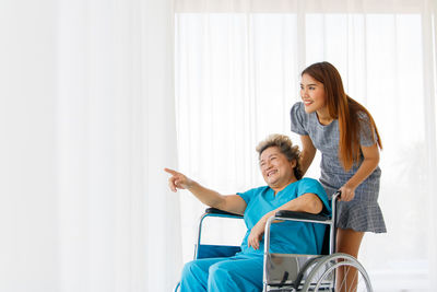 Happy young woman sitting on floor