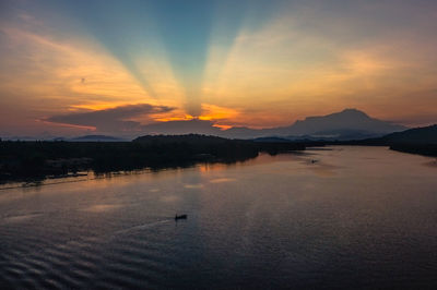 Scenic view of lake against dramatic sky