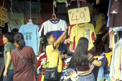 Rear view of people standing on street