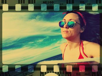 Young woman wearing sunglasses against sky