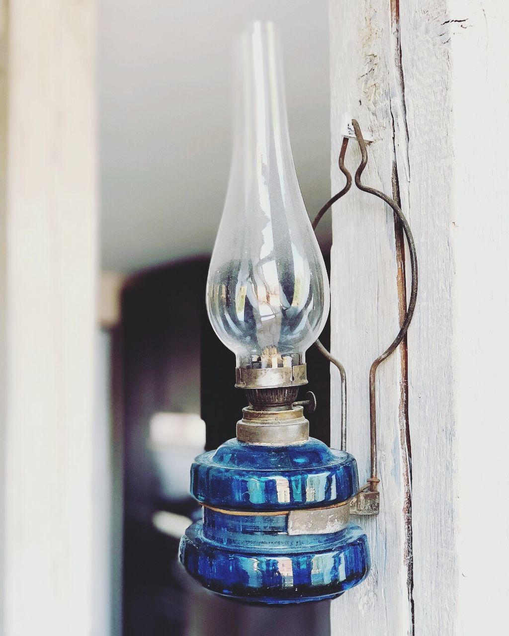 CLOSE-UP OF ILLUMINATED LIGHT BULB HANGING ON WALL