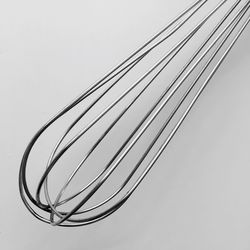 Close-up of wire whisk on white background