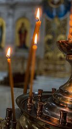 Close-up of lit candles in temple