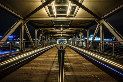 Illuminated railroad station platform at night