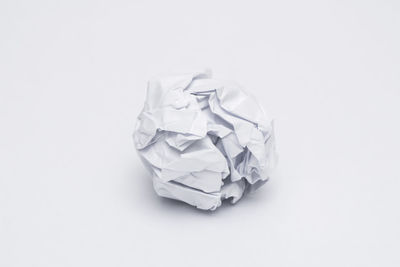 High angle view of garbage on paper against white background