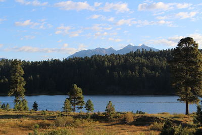 Scenic view of river and mountains against sky