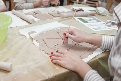 High angle view of woman hand holding paper