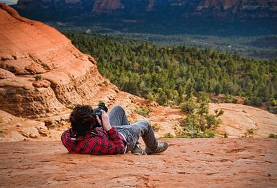 Full length of woman sitting on rock