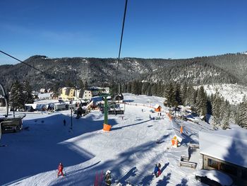 High angle view of ski lift against snowcapped mountain