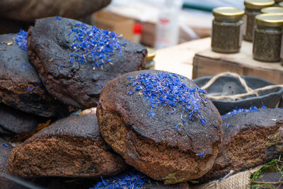 Homemade black cereal and juniper bread with hemp seeds in a street food traditional market