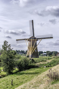 Traditional windmill against sky