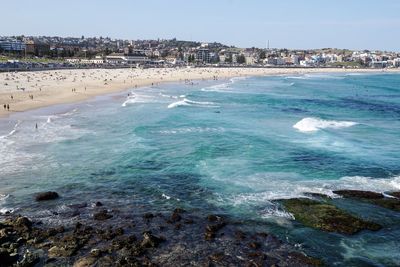 Scenic view of beach and city against sky