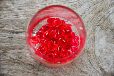 Directly above shot of red gelatin dessert in jar on table