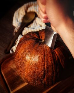 Midsection of woman holding pumpkin